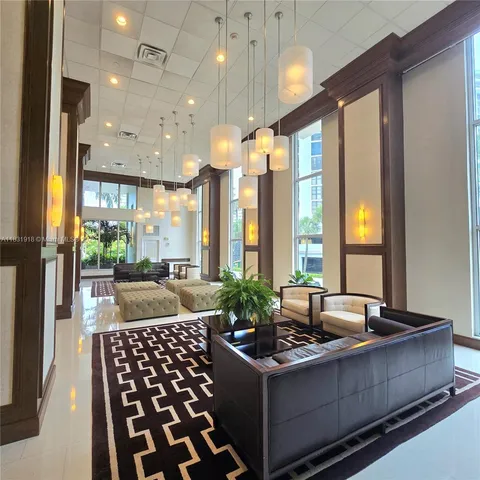 a view of a house with a yard and potted plants