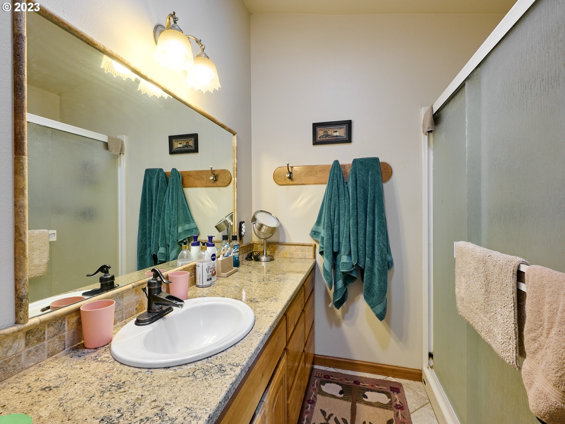 15360 May Road Dallas, OR 97338 - Photo 18 of 48 a bathroom with a sink a mirror and vanity