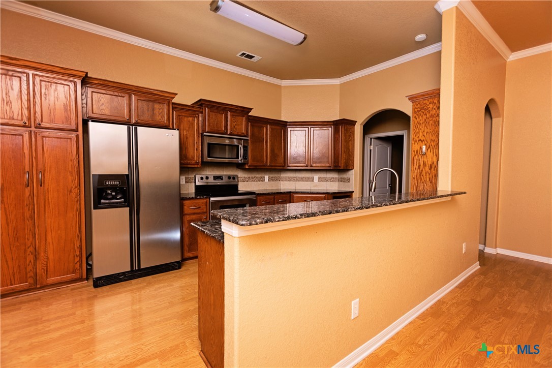 115 Squire Loop Belton, TX 76513 - Photo 13 of 38 a kitchen with stainless steel appliances granite countertop a refrigerator and a stove