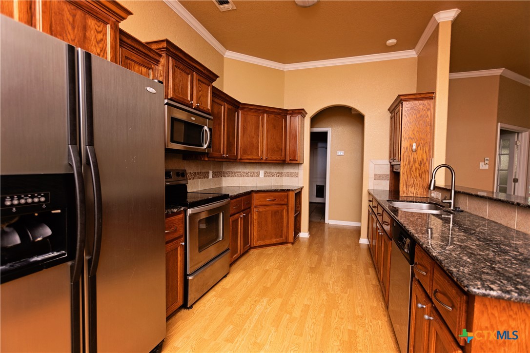 115 Squire Loop Belton, TX 76513 - Photo 15 of 38 a kitchen with stainless steel appliances granite countertop a refrigerator a stove top oven a sink and dishwasher