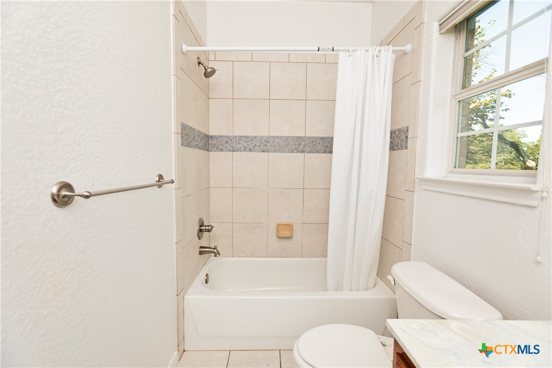 115 Squire Loop Belton, TX 76513 - Photo 24 of 38 a bathroom with a toilet and a shower