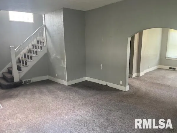 a view of an empty room with stairs