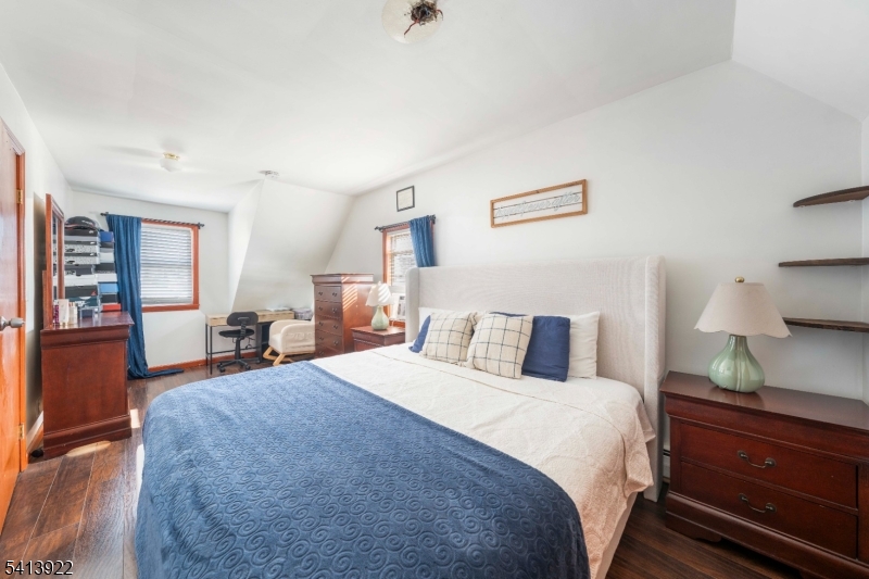 828 Allen Street Linden, NJ 07036 - Photo 11 of 18 a bedroom with a bed and wooden floor