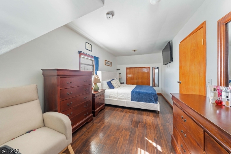 828 Allen Street Linden, NJ 07036 - Photo 12 of 18 a bedroom with a bed and wooden floor