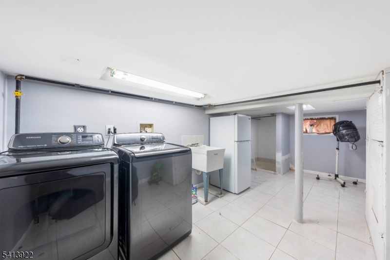 828 Allen Street Linden, NJ 07036 - Photo 16 of 18 a kitchen with a stove and a refrigerator