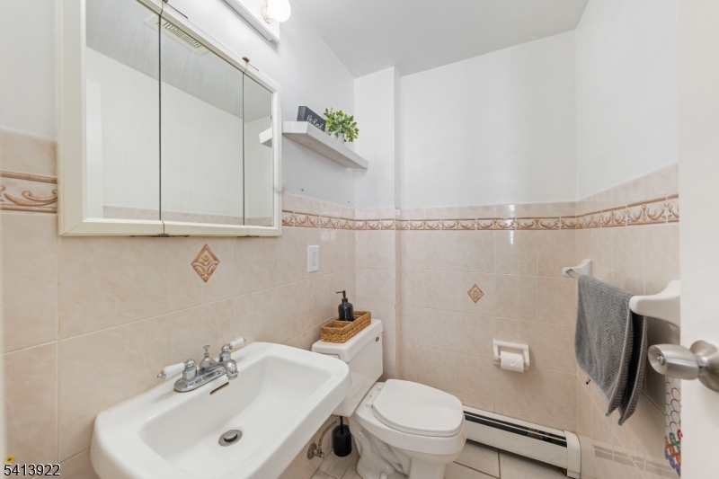 828 Allen Street Linden, NJ 07036 - Photo 10 of 18 a bathroom with a sink a toilet and shower