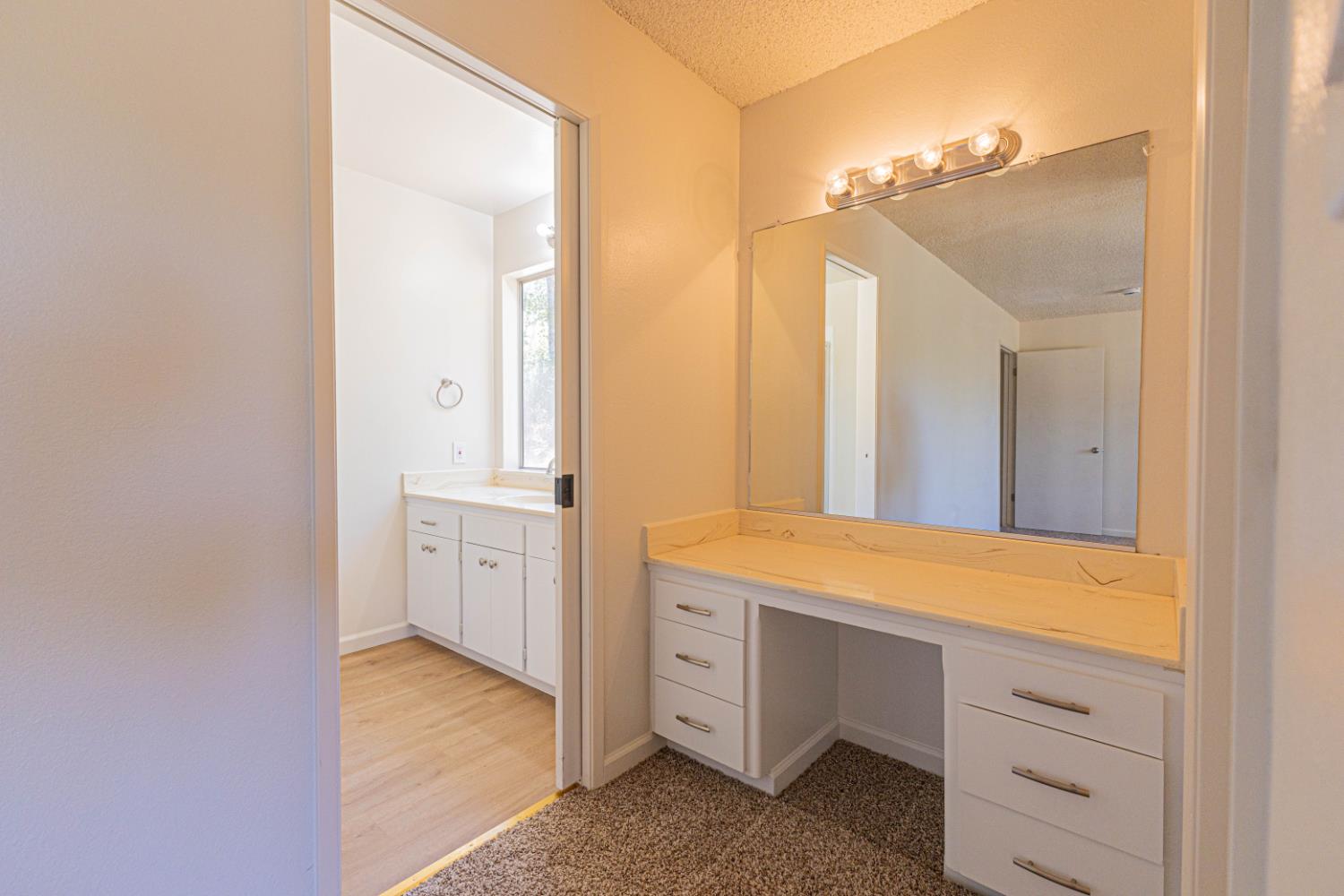 31612 Duke Road North Fork, CA 93643 - Photo 24 of 44 a bathroom with a double vanity sink a mirror and a bathtub