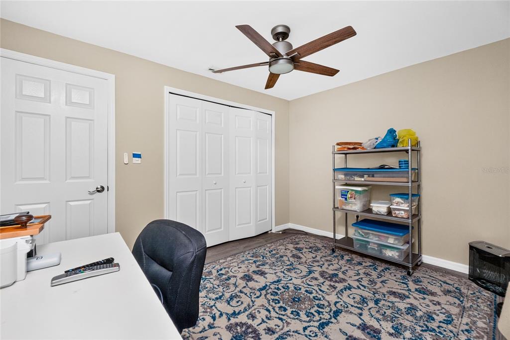 219 Caddy Road Rotonda West, FL 33947 - Photo 35 of 89 a bedroom with a bed and a chandelier