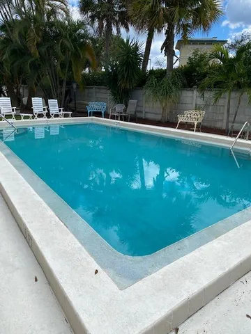 a view of a swimming pool with a table and chairs