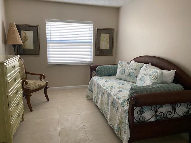 312 Southwind Drive, Unit 102 North Palm Beach, FL 33408 - Photo 11 of 18 a bedroom with a bed and a window