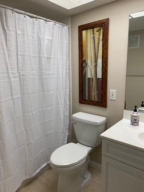 312 Southwind Drive, Unit 102 North Palm Beach, FL 33408 - Photo 12 of 18 a white toilet sitting next to a bathroom sink