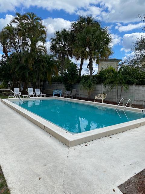 312 Southwind Drive, Unit 102 North Palm Beach, FL 33408 - Photo 14 of 18 a view of a swimming pool with a yard