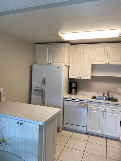 312 Southwind Drive, Unit 102 North Palm Beach, FL 33408 - Photo 6 of 18 a kitchen with stainless steel appliances a refrigerator sink and cabinets