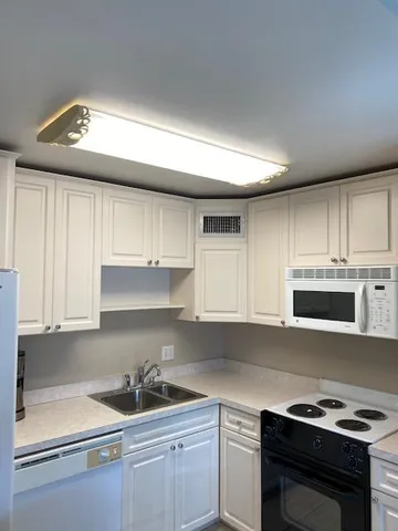 a kitchen with a sink and cabinets