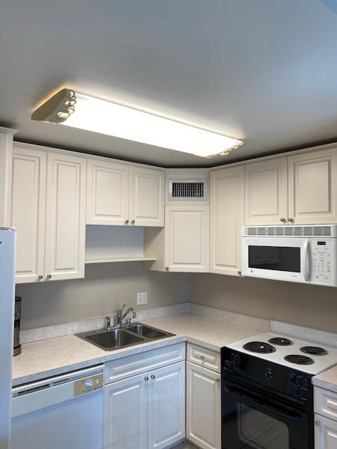 312 Southwind Drive, Unit 102 North Palm Beach, FL 33408 - Photo 7 of 18 a kitchen with a sink and cabinets