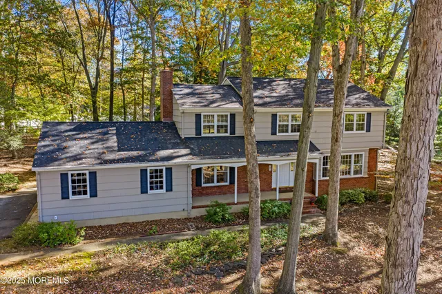 front view of a house with a tree