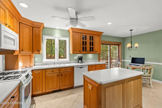 a kitchen with a stove a sink dishwasher and a refrigerator