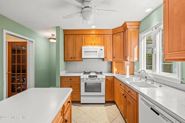 a kitchen with stainless steel appliances a stove a sink and a refrigerator