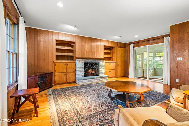 a living room with a fireplace furniture and a large window