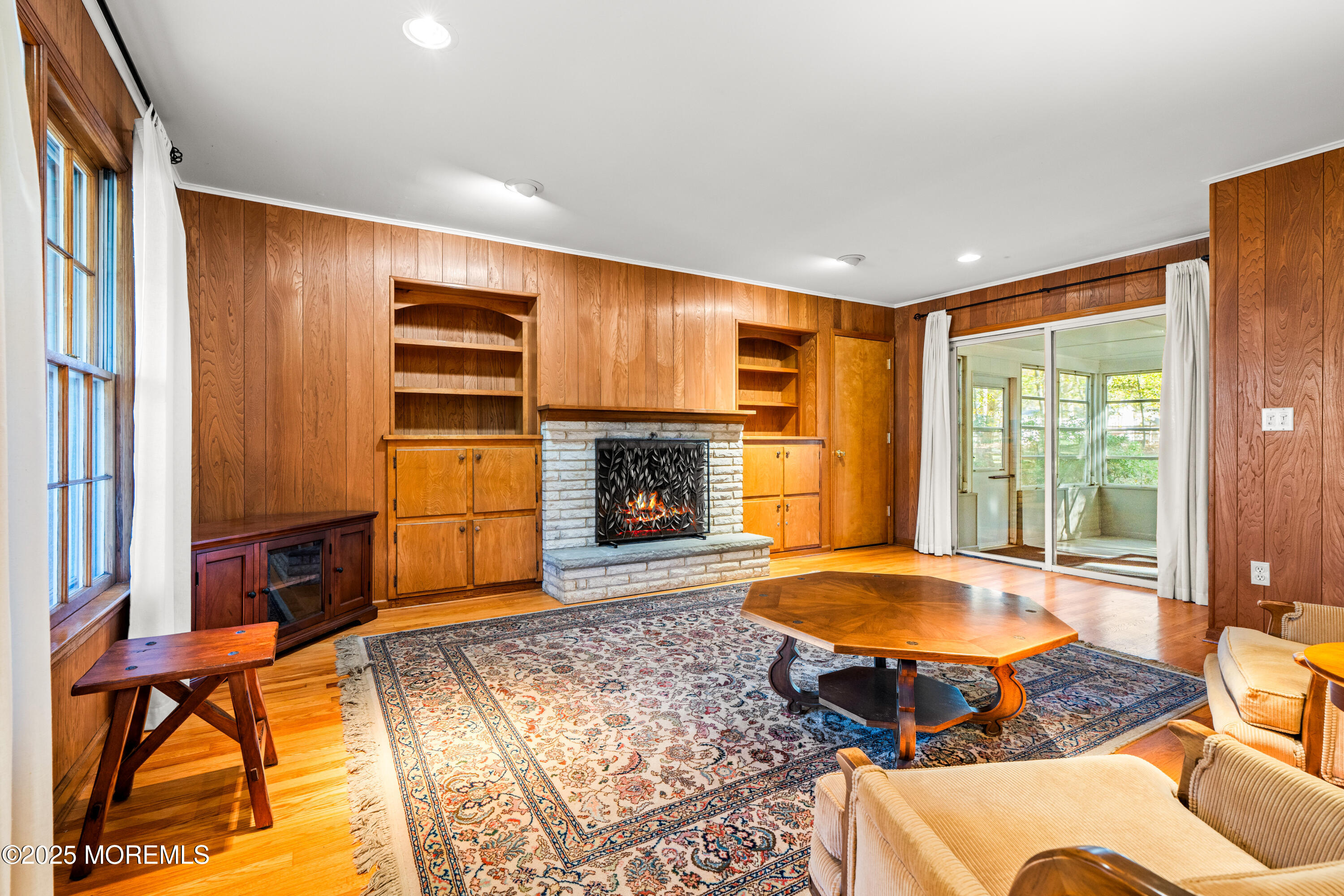 4 Brookside Drive Colts Neck, NJ 07722 - Photo 25 of 46 a living room with a fireplace furniture and a large window