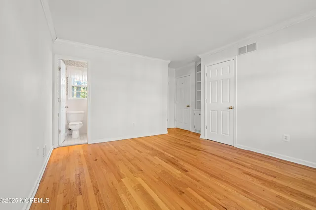 a bedroom with a bed and a mirror