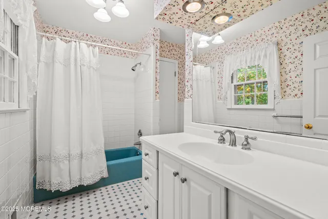 a bathroom with a sink a mirror and a shower