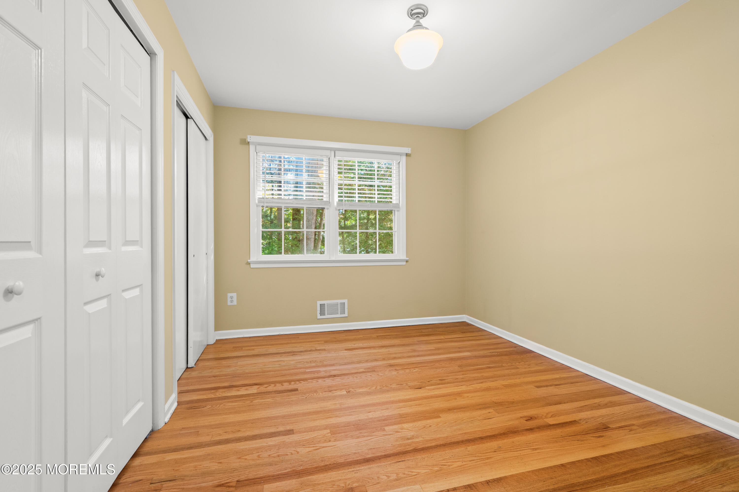 4 Brookside Drive Colts Neck, NJ 07722 - Photo 35 of 46 a view of an empty room with wooden floor and a window