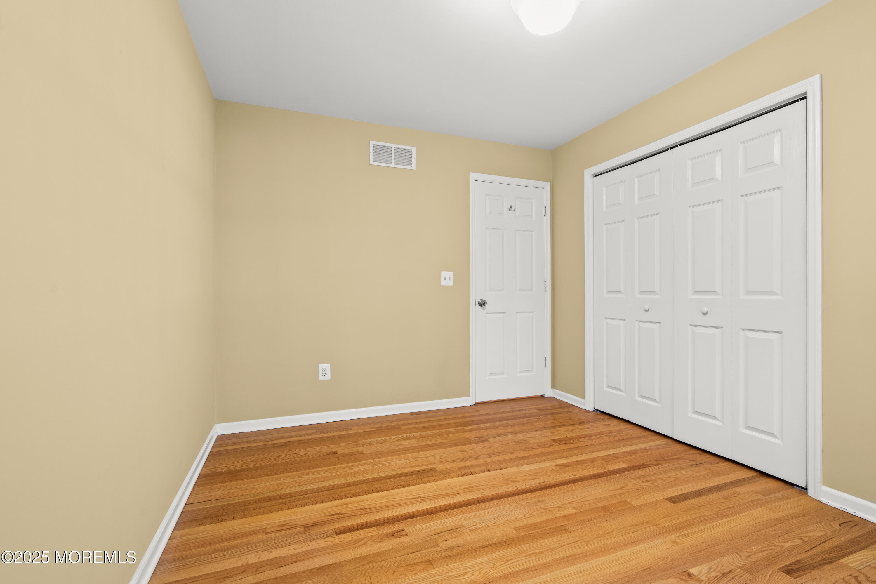 4 Brookside Drive Colts Neck, NJ 07722 - Photo 36 of 46 a view of a room with wooden floor and white walls