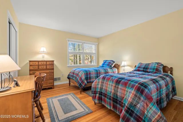 a bedroom with two beds and a flat screen tv