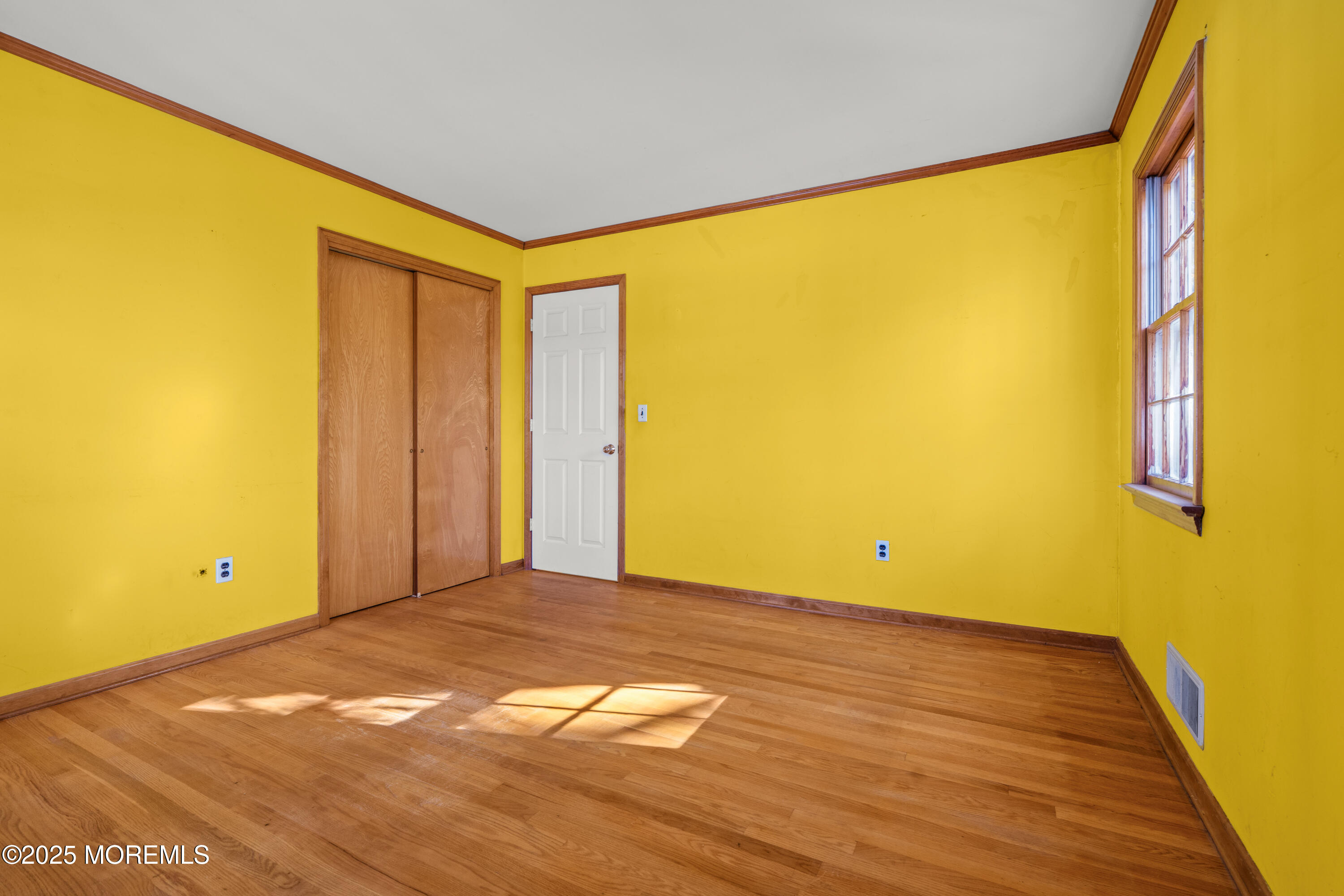 4 Brookside Drive Colts Neck, NJ 07722 - Photo 40 of 46 a view of an empty room with wooden floor and a window