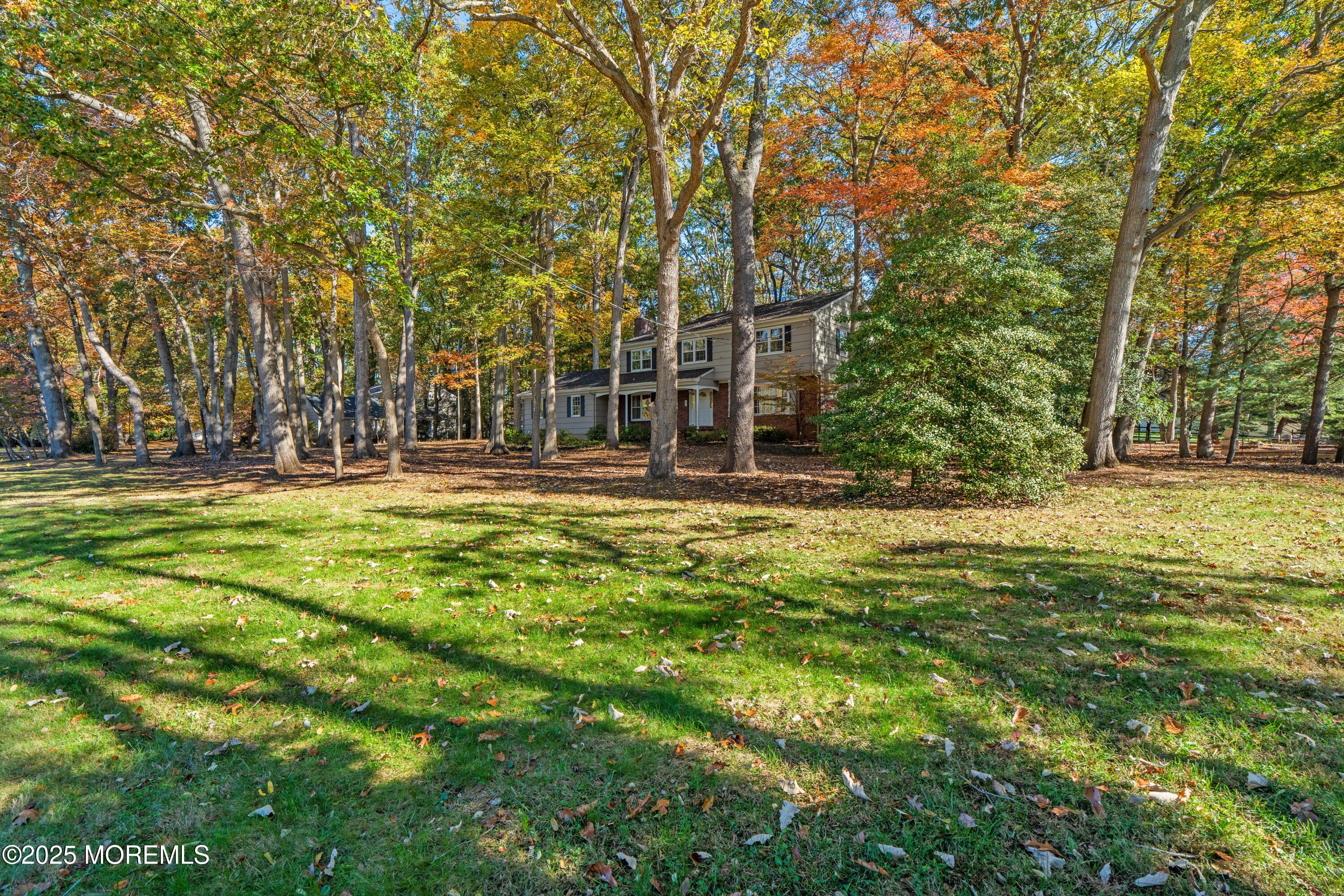 4 Brookside Drive Colts Neck, NJ 07722 - Photo 4 of 46 a view of swimming pool with outdoor seating and trees