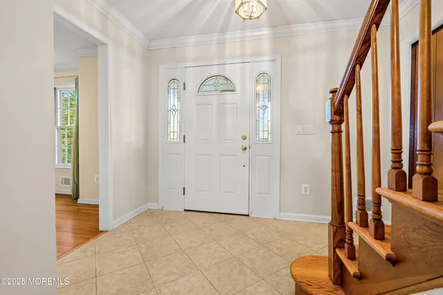 a view of an entryway with wooden floor and door