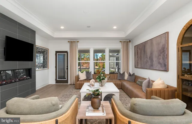 a large kitchen with stainless steel appliances a stove a sink dishwasher and a dining table with the living room view