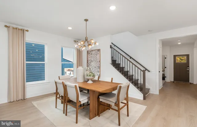 a view of a dining room with furniture and chandelier