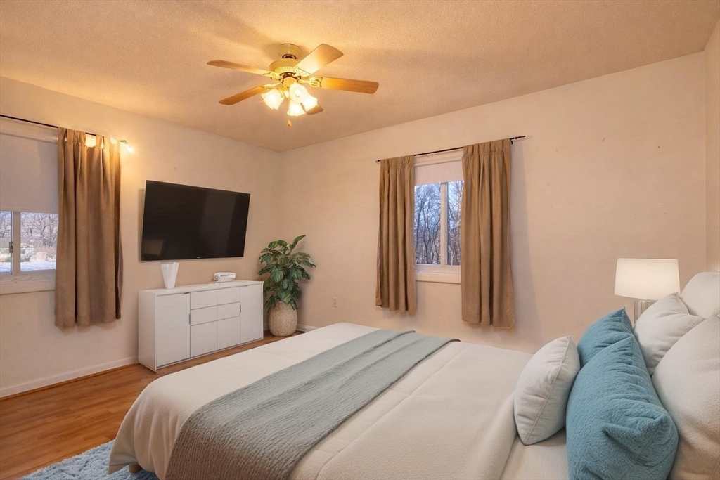 121 Bailey Street, Unit F54 Worcester, MA 01602 - Photo 11 of 15 a bedroom with a large bed and a flat screen tv