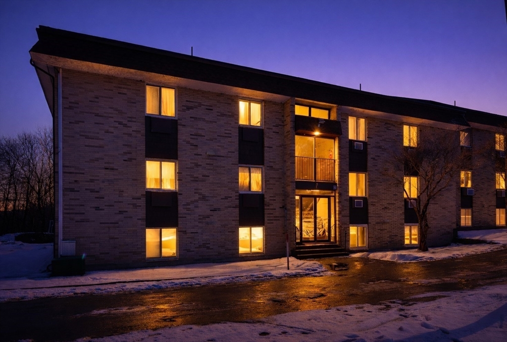 121 Bailey Street, Unit F54 Worcester, MA 01602 - Photo 2 of 15 a front view of a building with glass windows and a yard