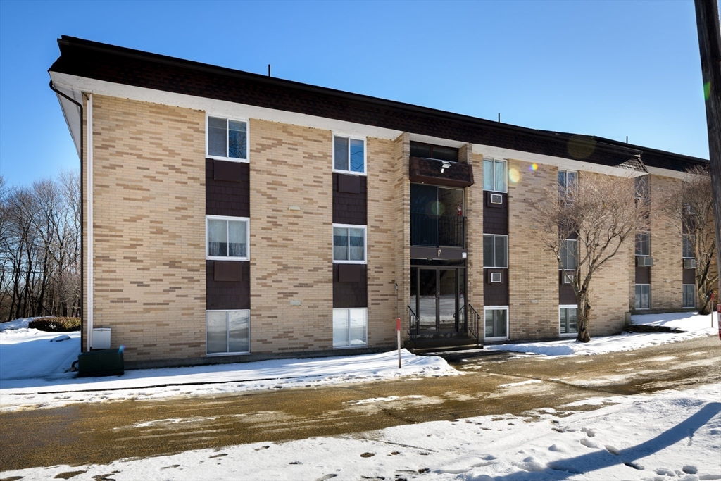 121 Bailey Street, Unit F54 Worcester, MA 01602 - Photo 4 of 15 a view of a brick house with a large windows