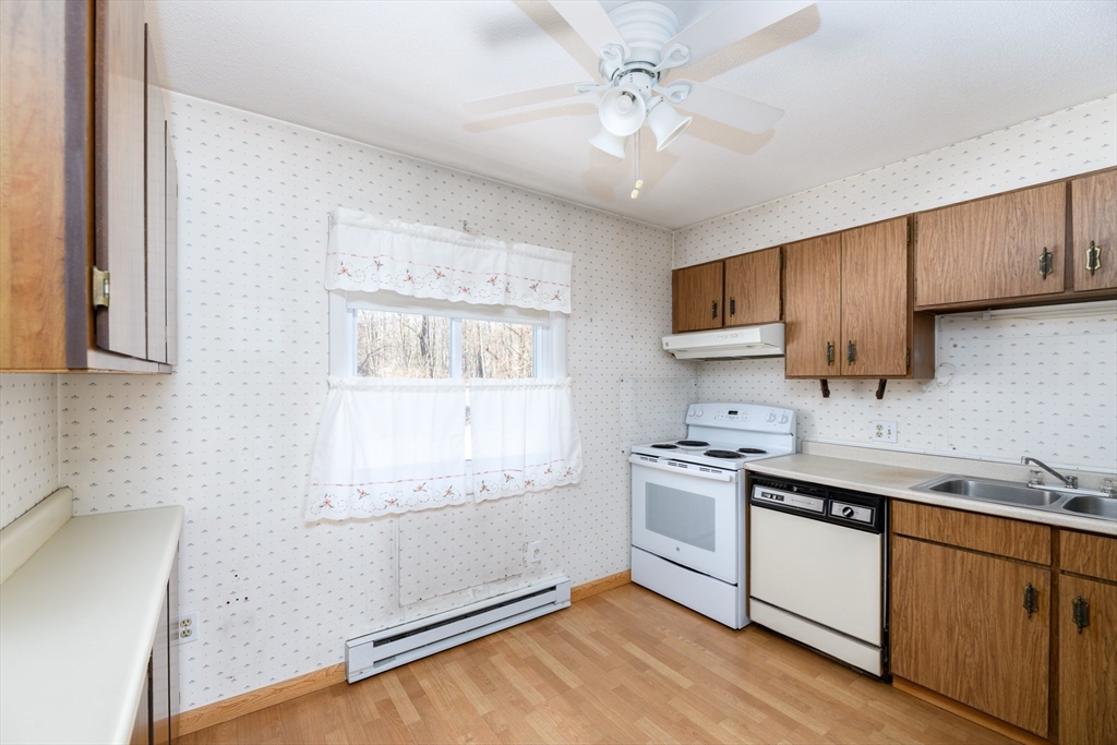 121 Bailey Street, Unit F54 Worcester, MA 01602 - Photo 6 of 15 a kitchen with stainless steel appliances granite countertop a sink a stove a refrigerator cabinets and a window