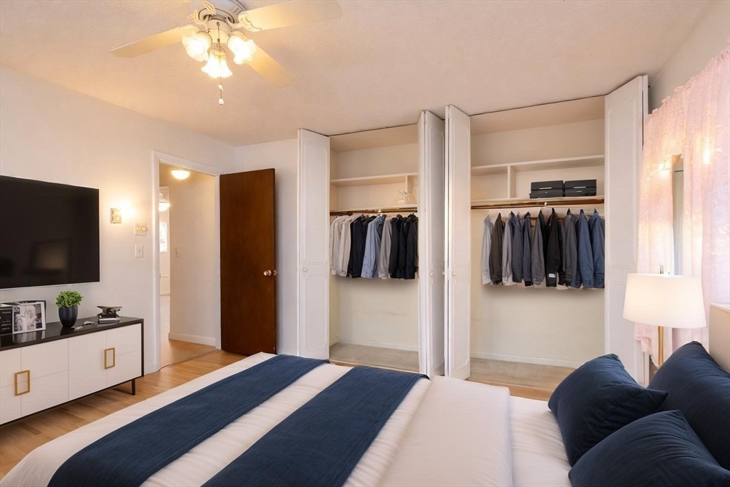 121 Bailey Street, Unit F54 Worcester, MA 01602 - Photo 10 of 15 a bedroom with a bed and flat screen tv