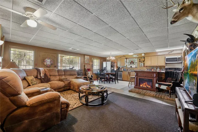 a living room with furniture a fireplace and a dining table