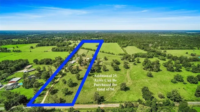 a view of swimming pool with a yard and potted plants