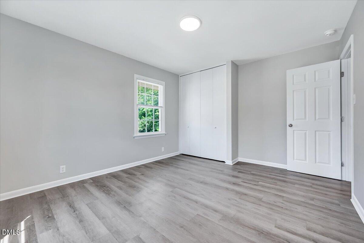 3408 Atlantic Avenue Raleigh, NC 27604 - Photo 44 of 48 an empty room with wooden floor and windows