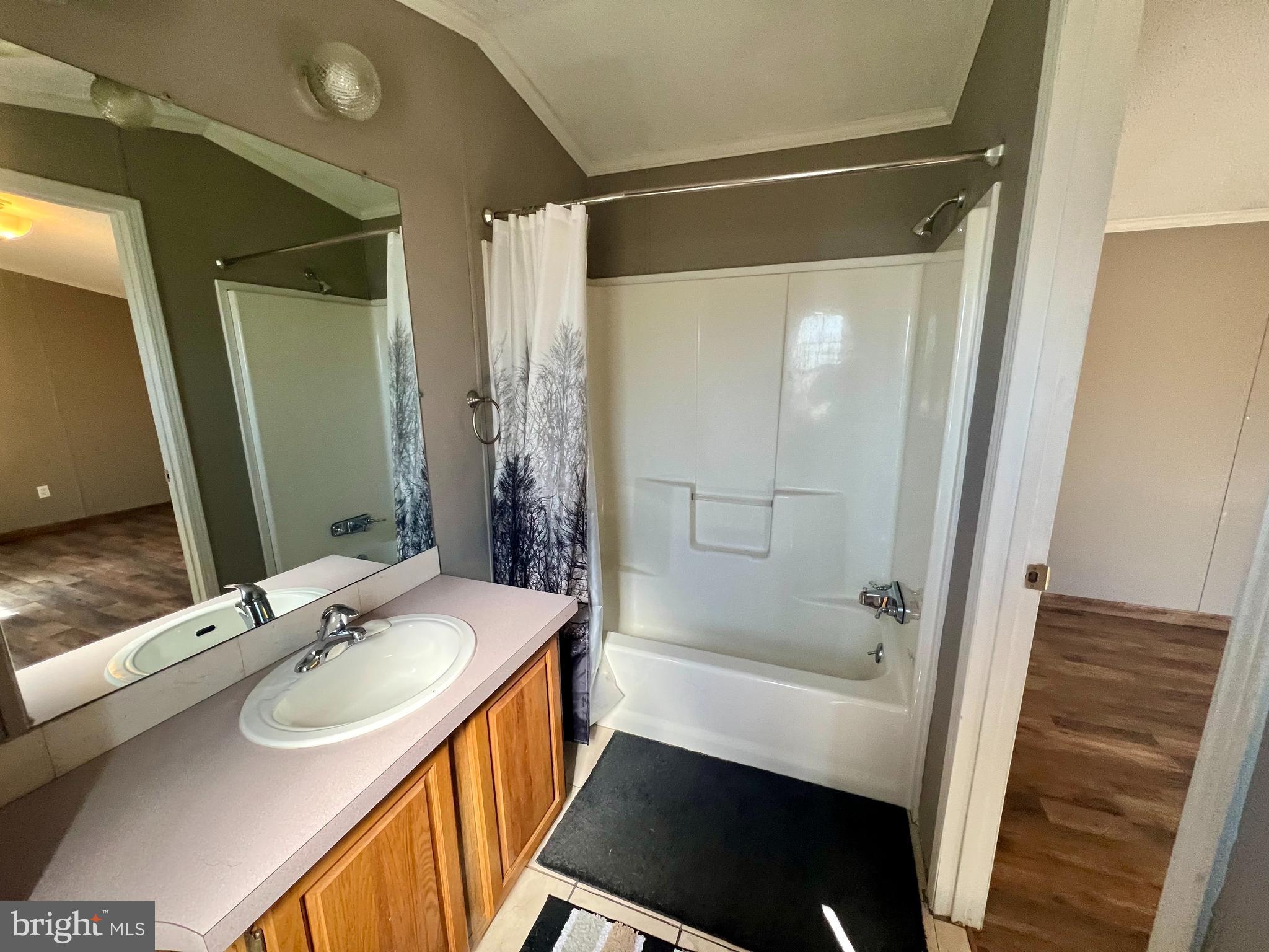 768 East Garden Road, Unit 14 Vineland, NJ 08360 - Photo 16 of 33 a bathroom with a sink a mirror and a bathtub