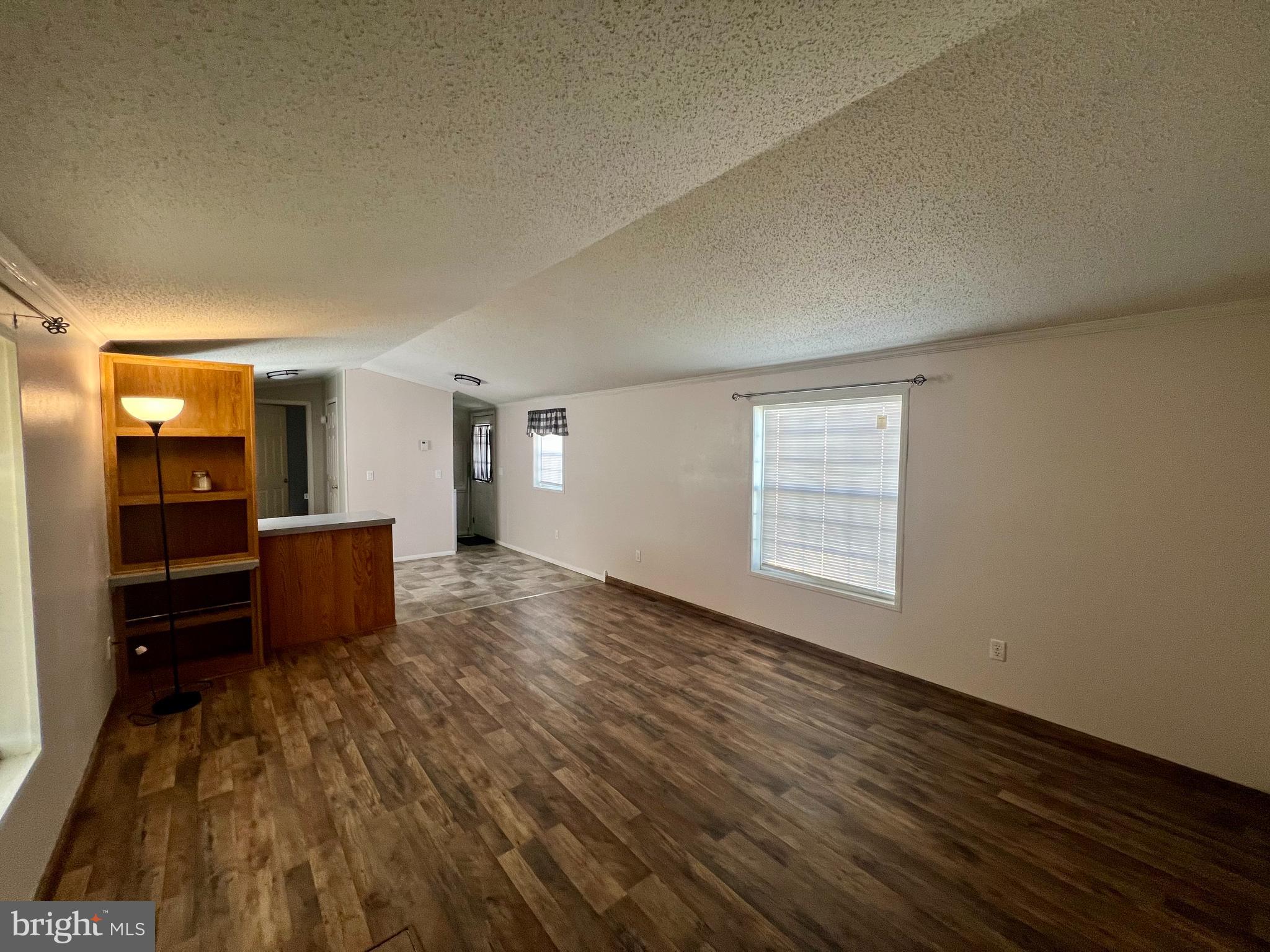 768 East Garden Road, Unit 14 Vineland, NJ 08360 - Photo 6 of 33 an empty room with kitchen space and wooden floor