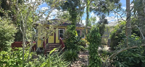 a view of a house with a tree