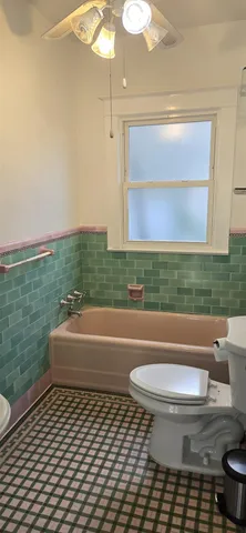 a bathroom with a sink a toilet and bathtub
