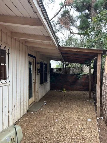 a backyard of a house with plants and trees