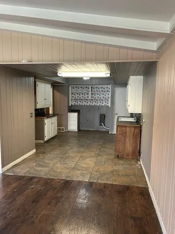 a view of kitchen with furniture and a refrigerator