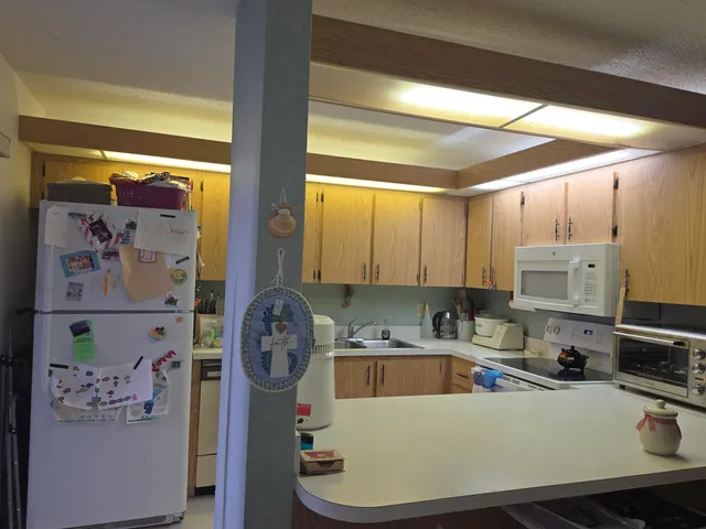 a kitchen with a refrigerator a stove and a sink