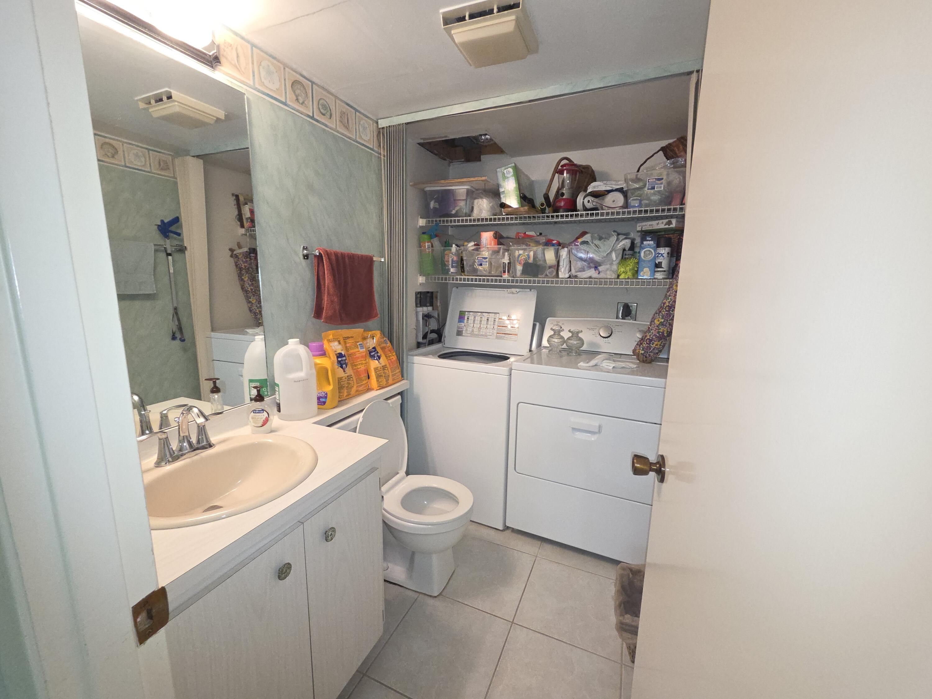 1170 6th Avenue, Unit 3A Vero Beach, FL 32960 - Photo 13 of 31 a bathroom with a sink toilet and vanity